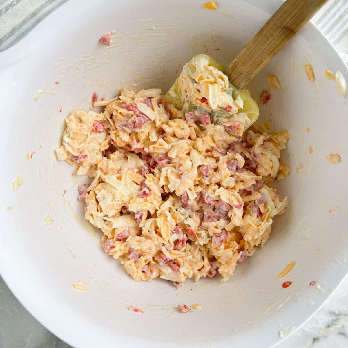 Bowl of pimento cheese with a spatula. 