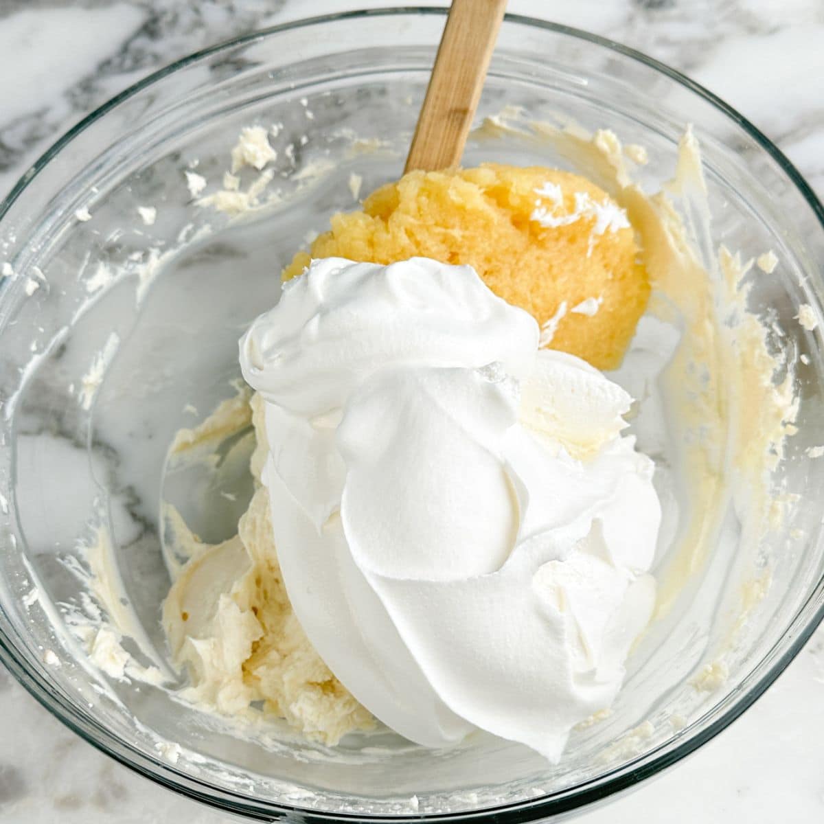 Bowl of whipped topping and crushed pineapples. 