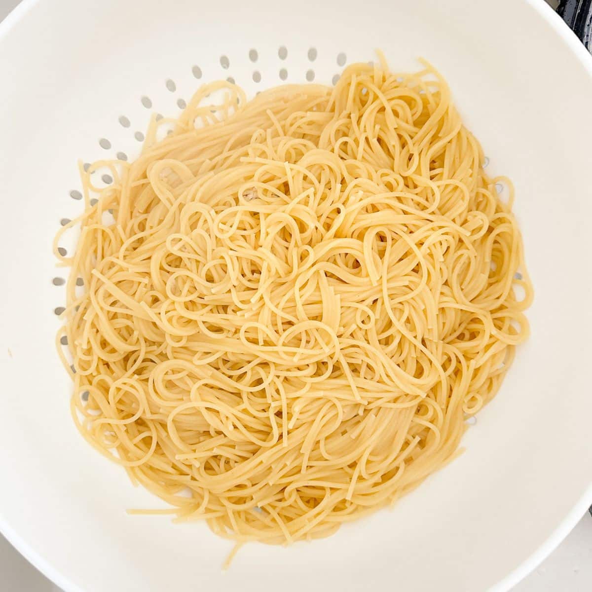 Colander with spaghetti noodles. 