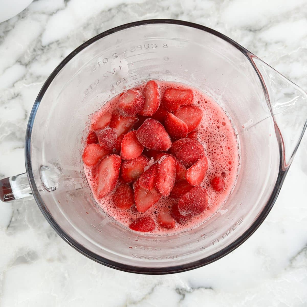 Bowl with sliced strawberries and JELL-O.