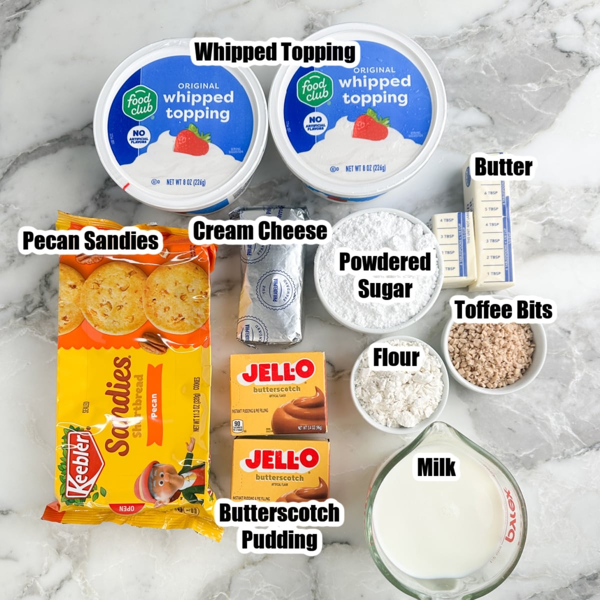 Whipped topping, pecan sandies, butterscotch pudding, milk, powdered sugar, butter, toffee bits, and cream cheese.