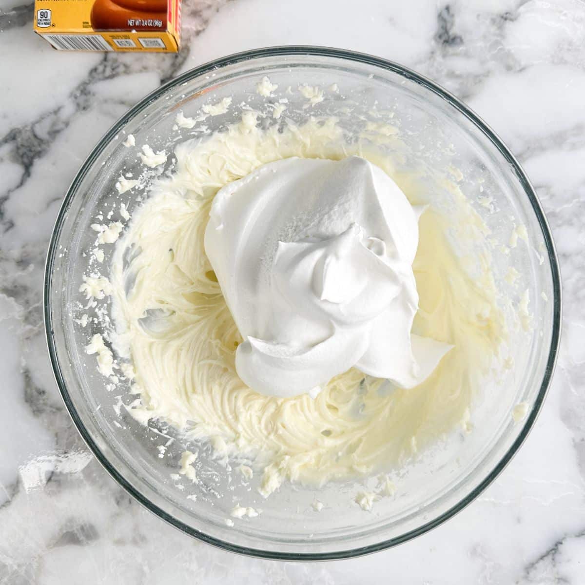 Bowl with cream cheese and Cool Whip.