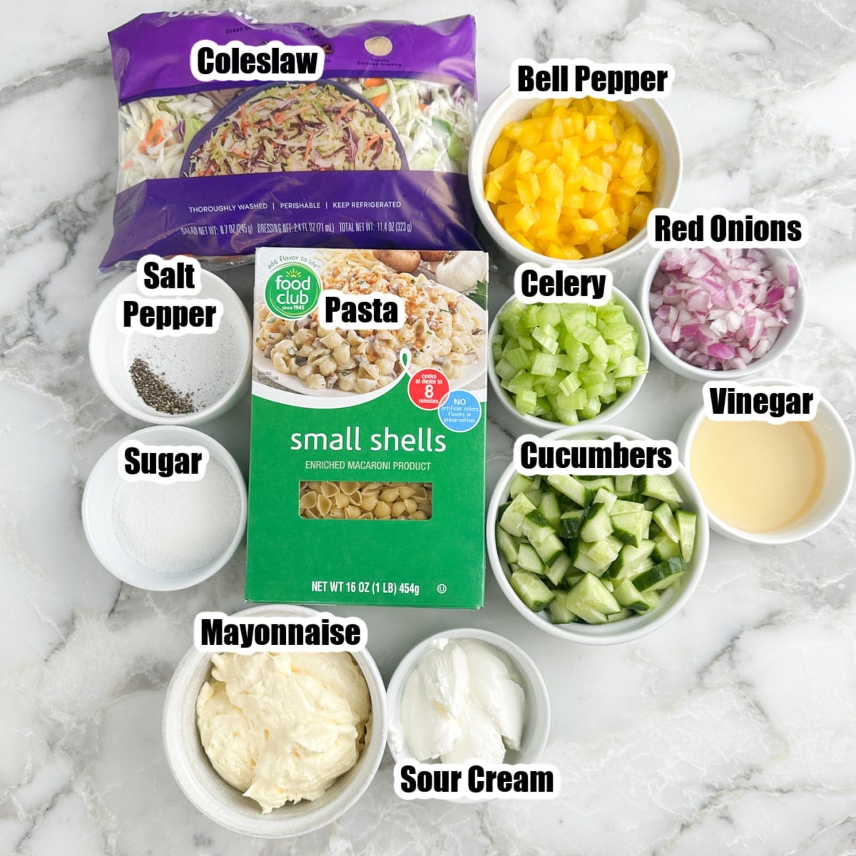 Bag of coleslaw, pasta, peppers, onions, celery, cucumbers, mayonnaise, sour cream, sugar, and vinegar.