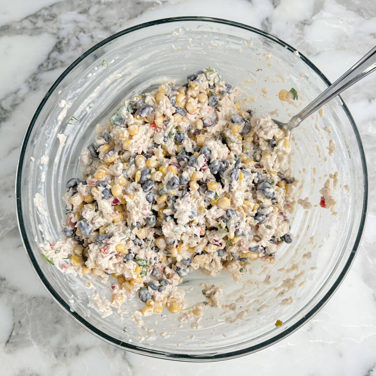 Bowl of southwest chicken salad with a spoon.