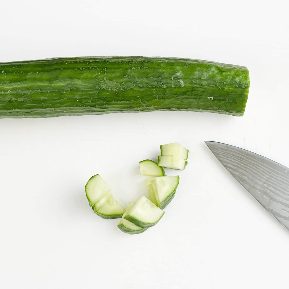 Diced cucumber with a knife.