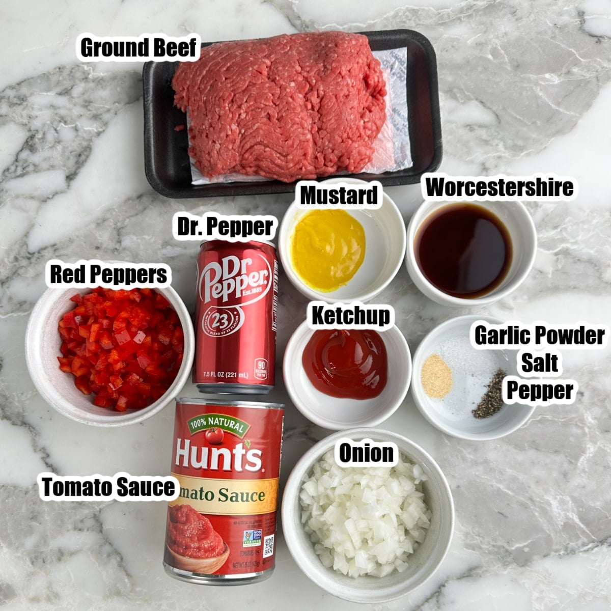 Ground beef, tomato sauce, Dr. Pepper, onions, peppers, ketchup, mustard, worcestershire, and seasonings.