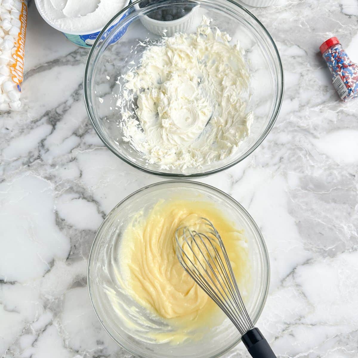 Bowl with pudding and bowl with whipped cream cheese.