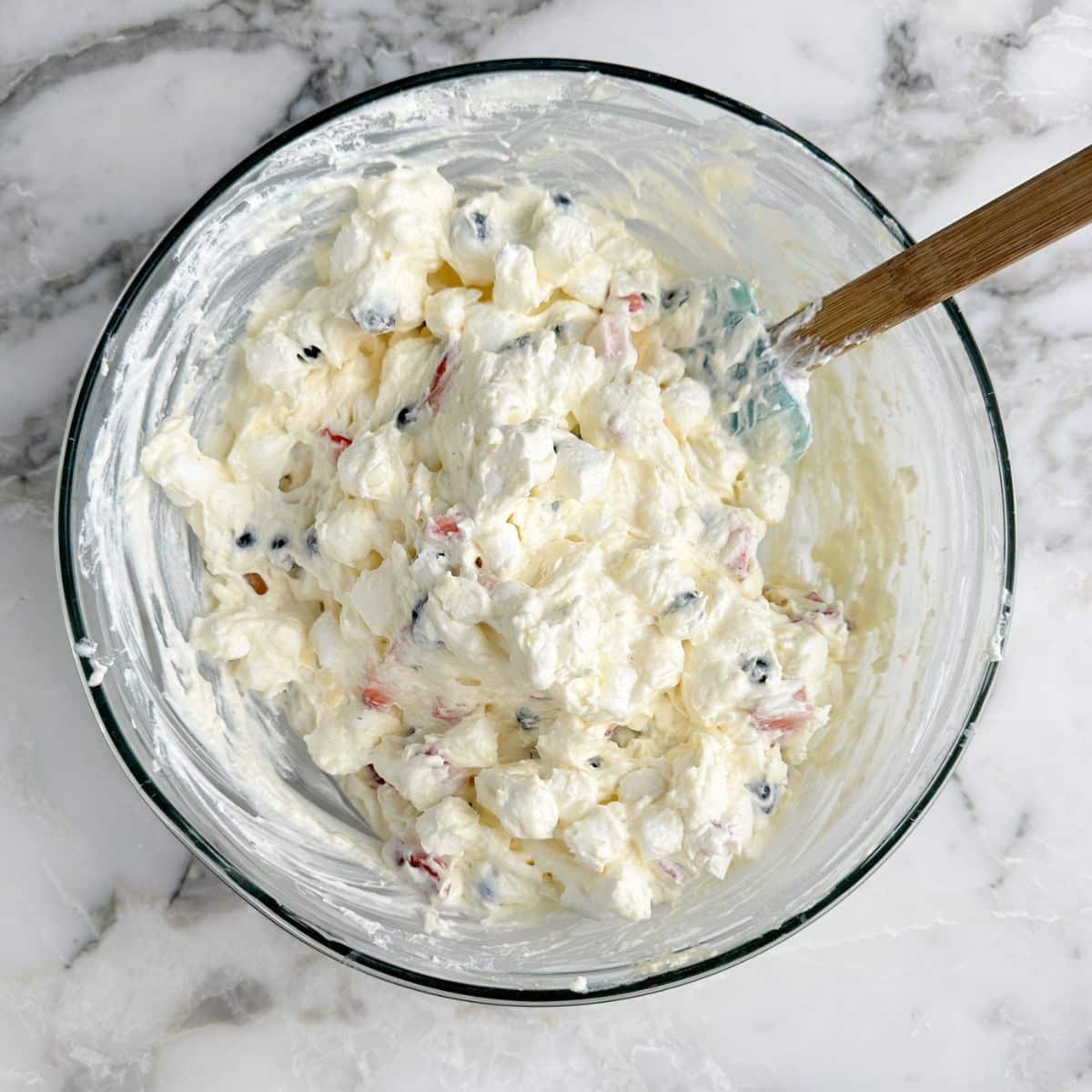 Bowl with red white and blue cheesecake dessert.