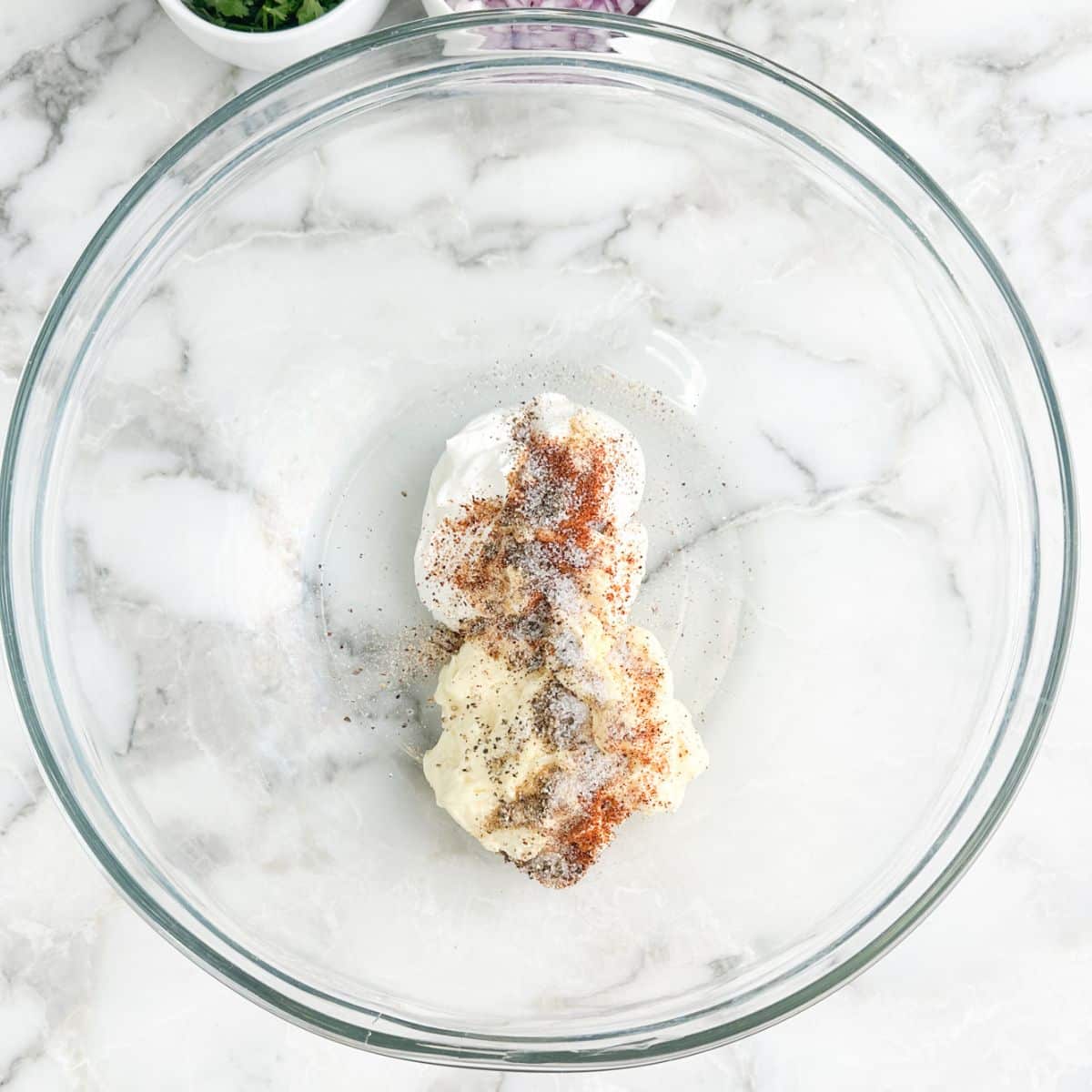 Bowl with sour cream, mayonnaise, and seasonings.
