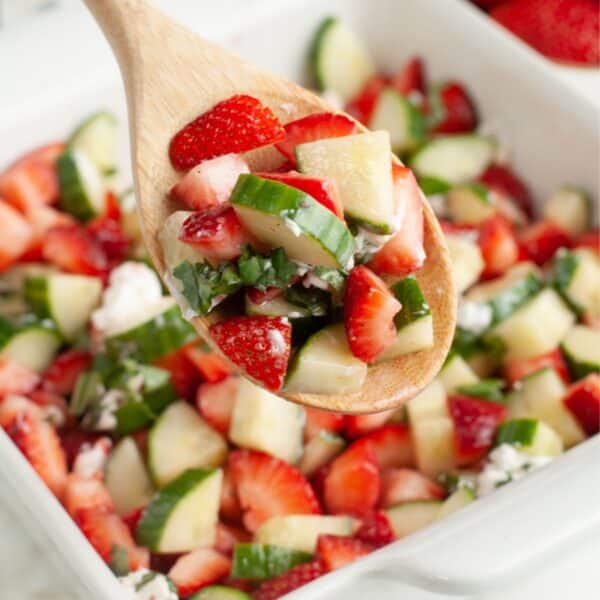 Spoon with strawberry cucumber salad.