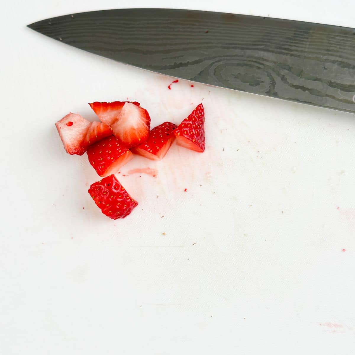 Diced strawberries with a knife.