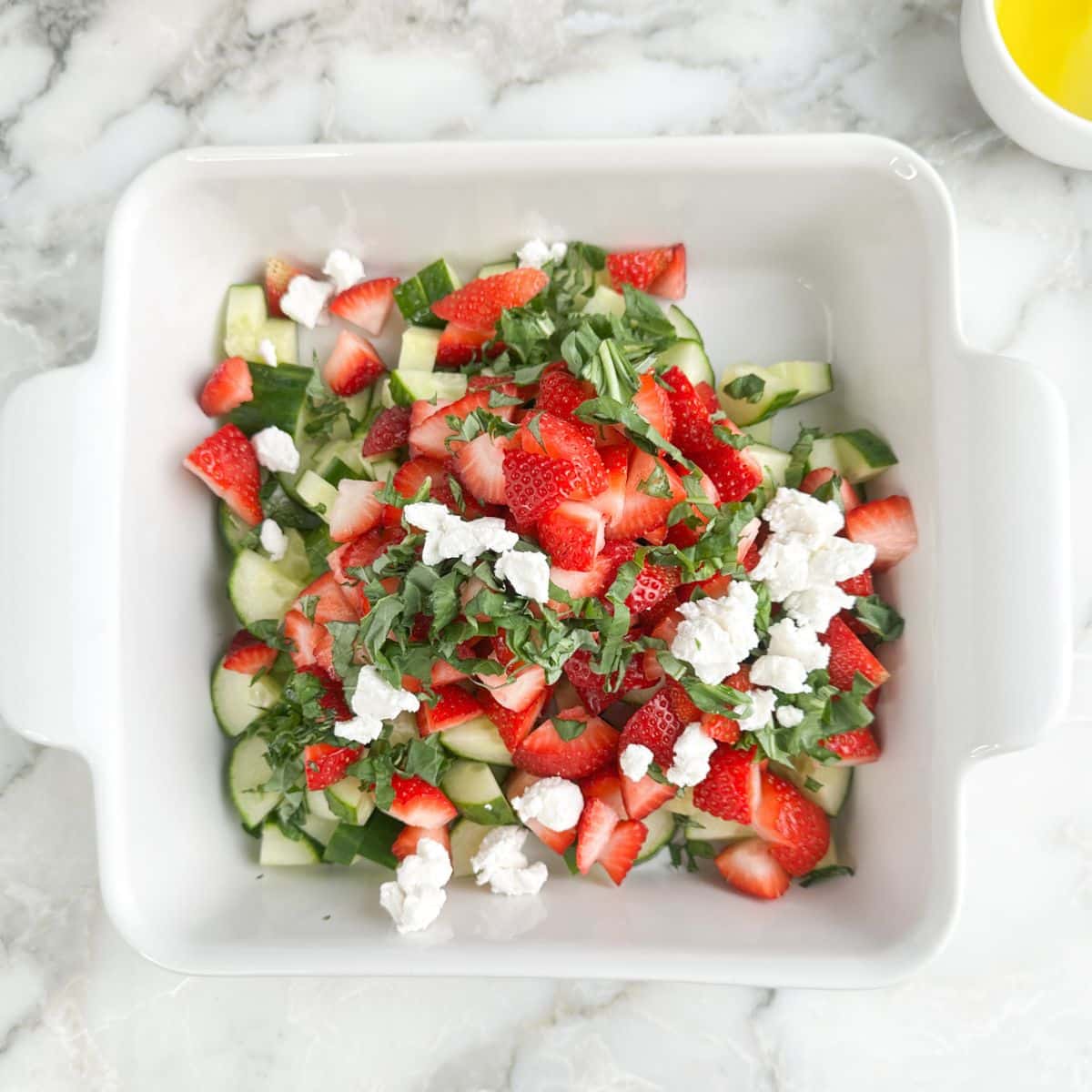 Dish with strawberry cucumber salad. 