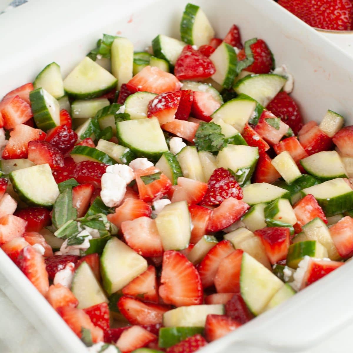 Dish with strawberry cucumber basil salad. 