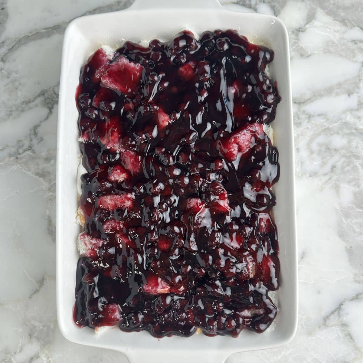 Baking dish with blueberry angel food cake dessert. 