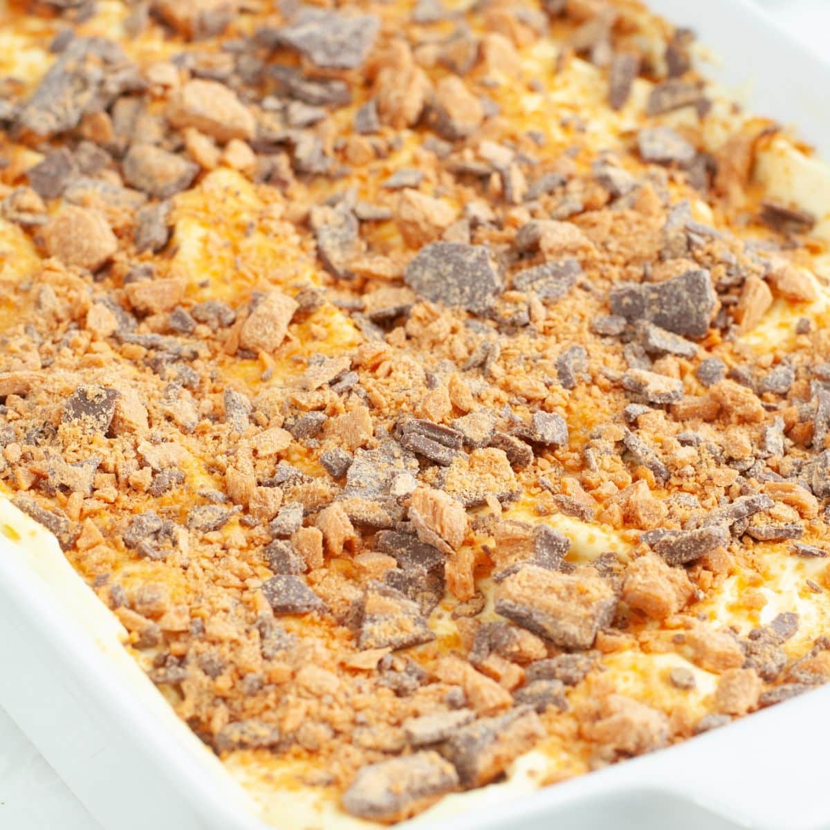 Baking dish with Butterfinger dessert.