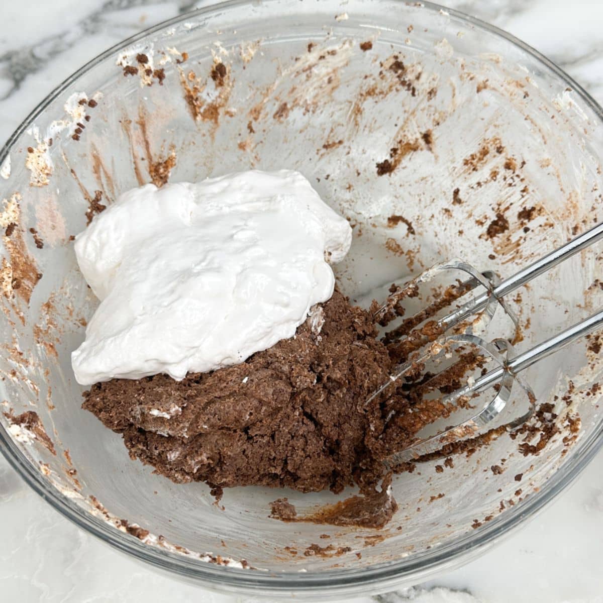 Bowl with chocolate pudding and marshmallow fluff. 