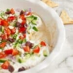 Greek layer dip in a pie dish.