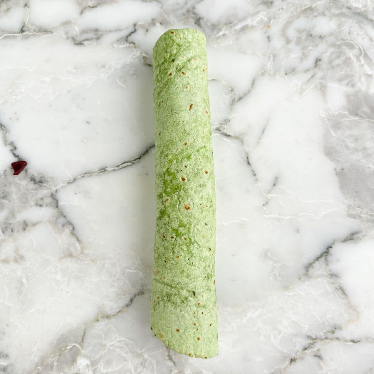 Green tortilla rolled up.
