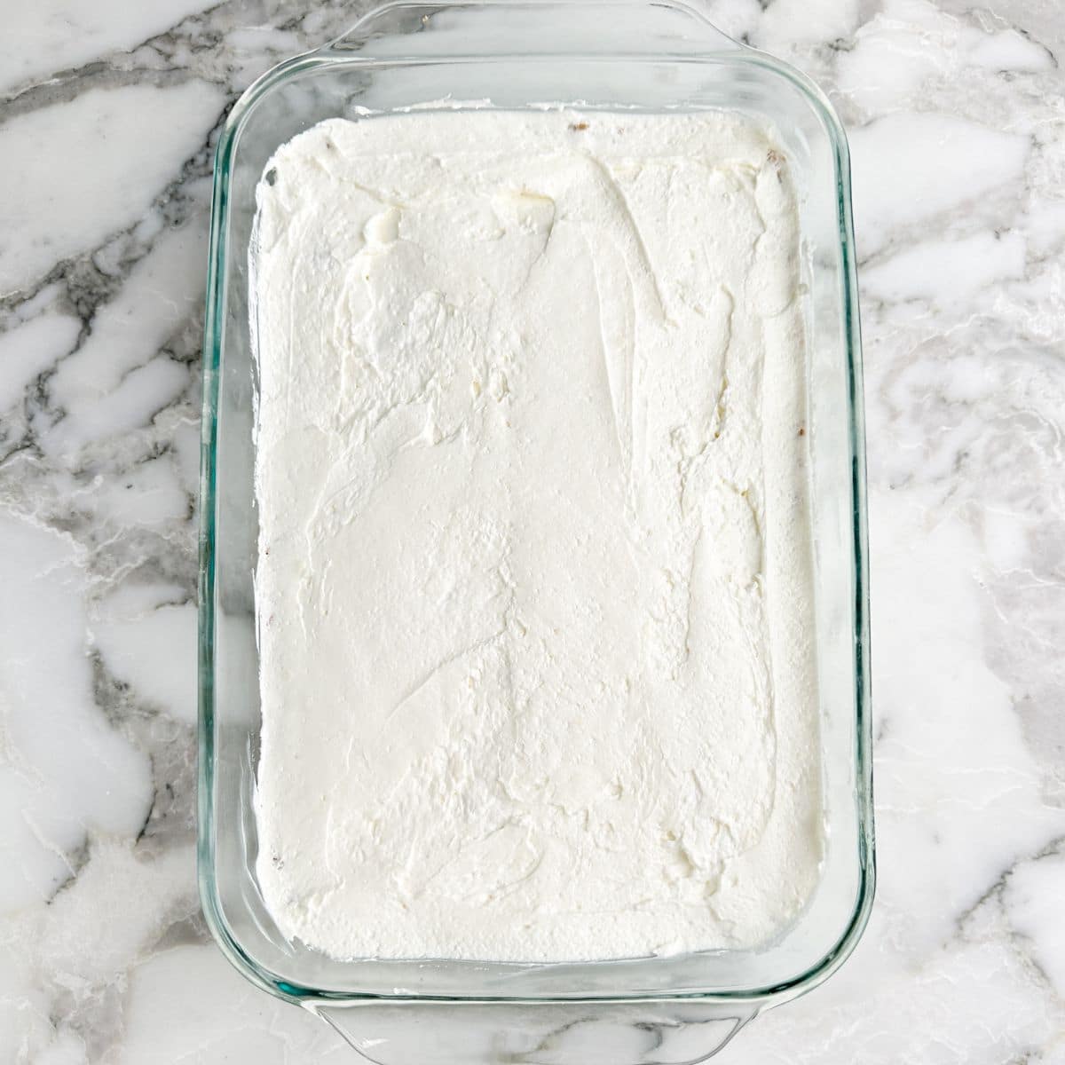 Creamy layer in a baking dish.