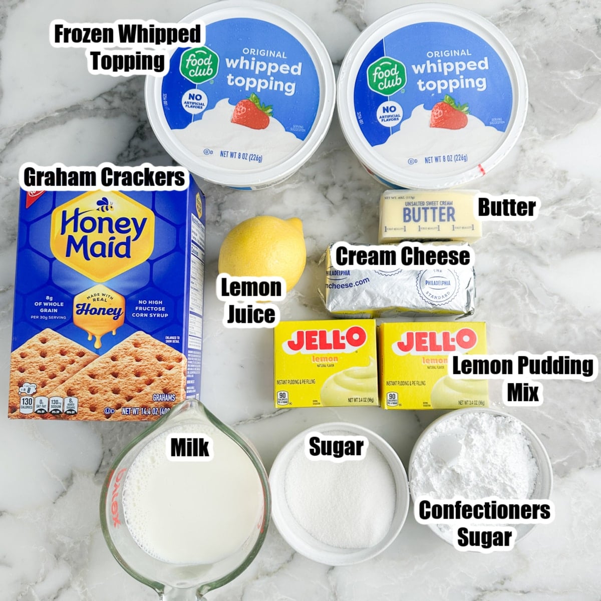 Frozen whipped topping, graham crackers, lemon, pudding mix, cream cheese, butter, milk, and sugar.