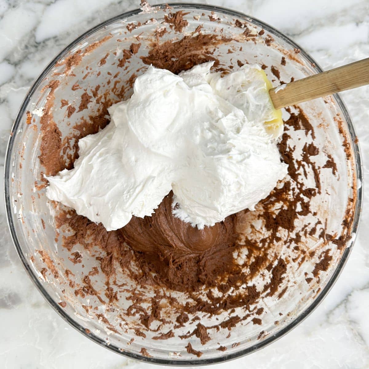 Bowl with chocolate pudding and whipped topping. 