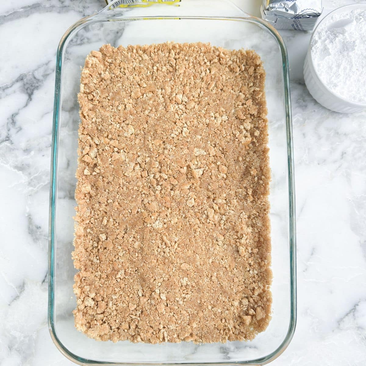 Graham cracker crush in a baking dish.