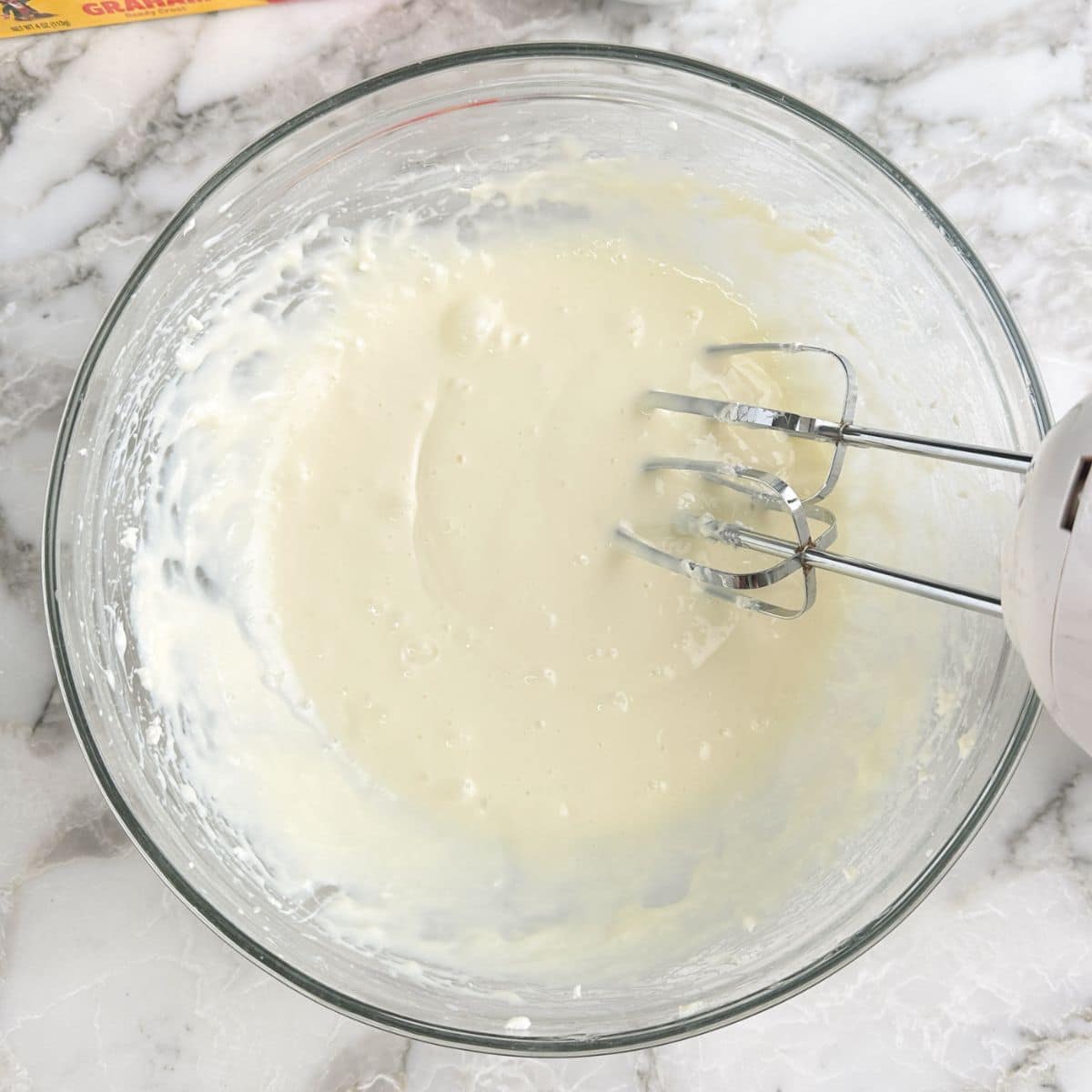 Bowl with beaten cream cheese.