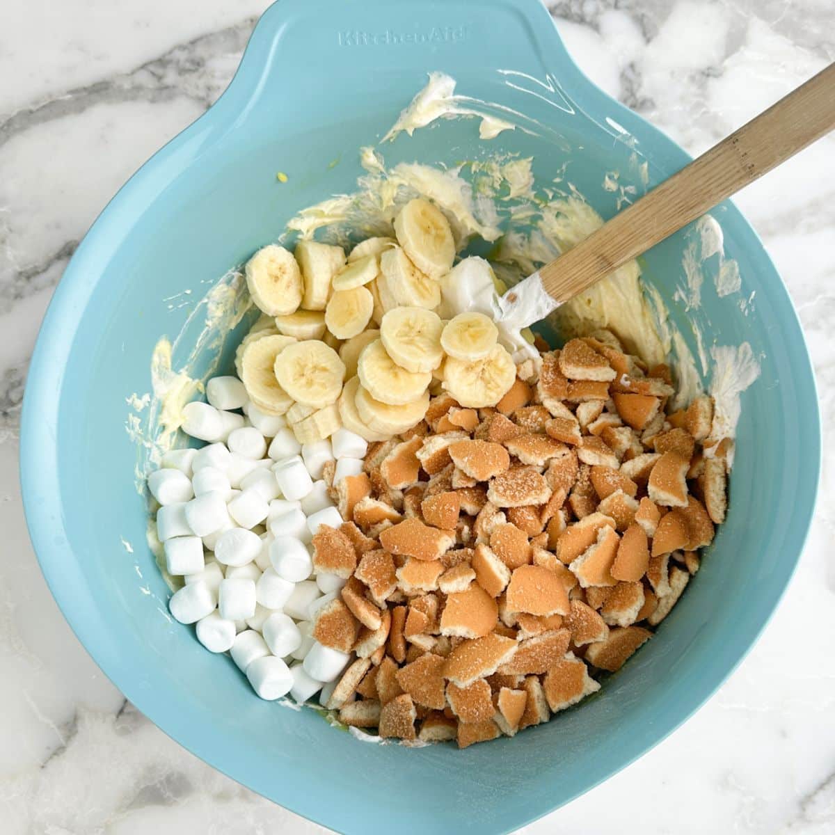 Bowl with vanilla pudding, bananas, mini marshmallows, vanilla wafers.