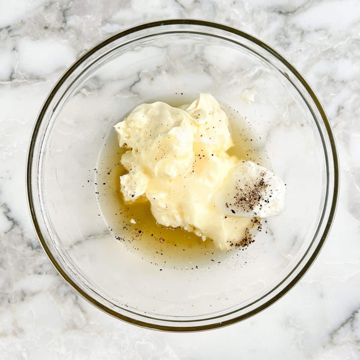 Bowl with mayonnaise, sour cream, vinegar. 