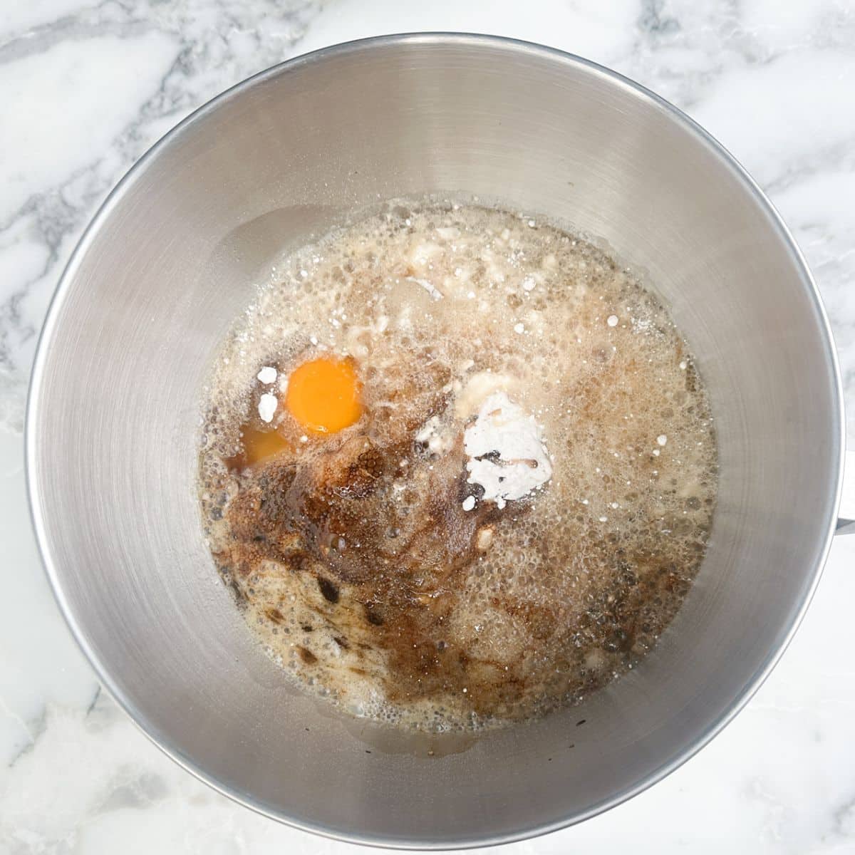 Mixing bowl with eggs, cake mix, and root beer.