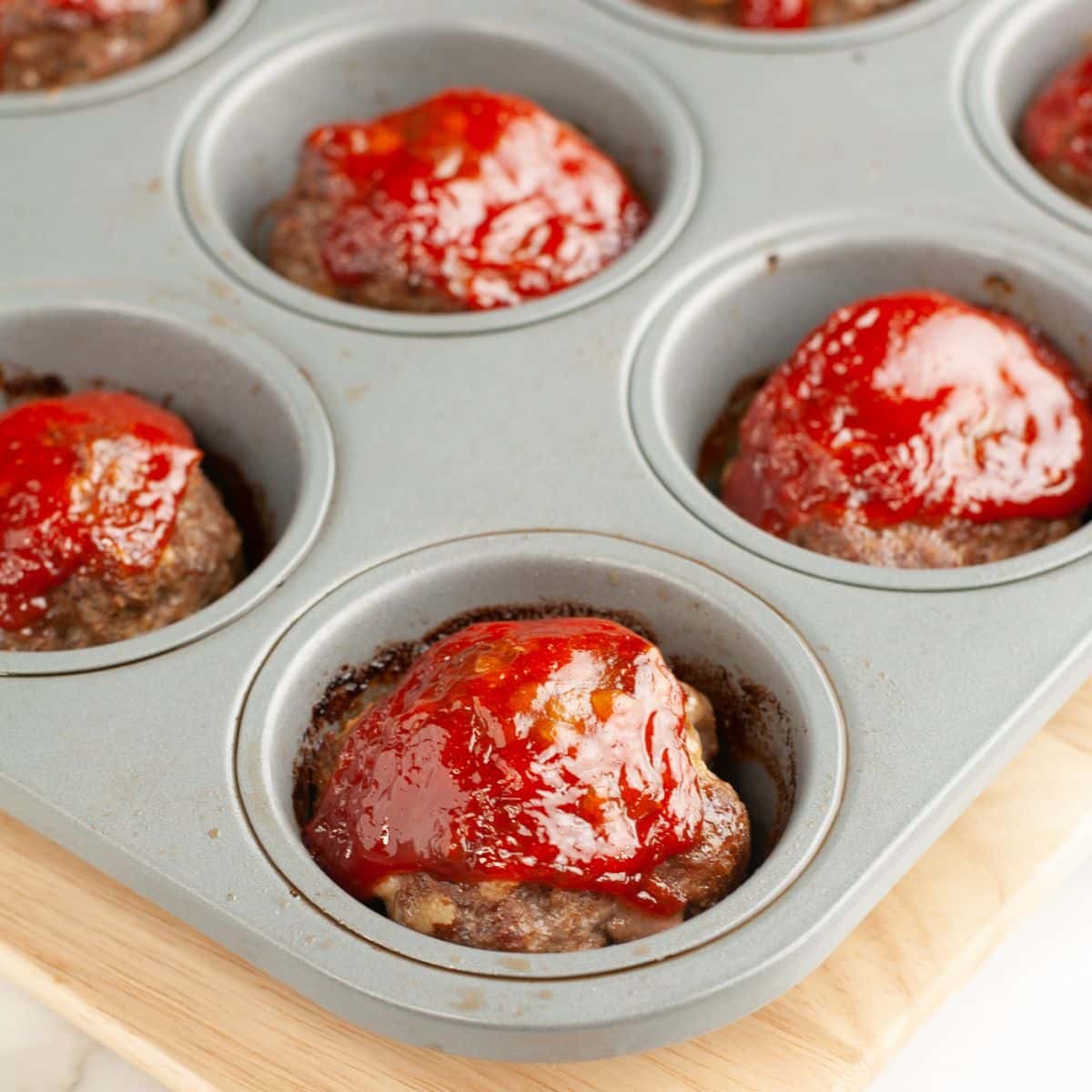Muffin tin with mini meatloaf muffins.