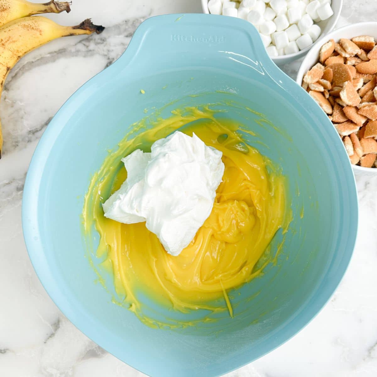 Bowl with vanilla pudding and whipped topping.