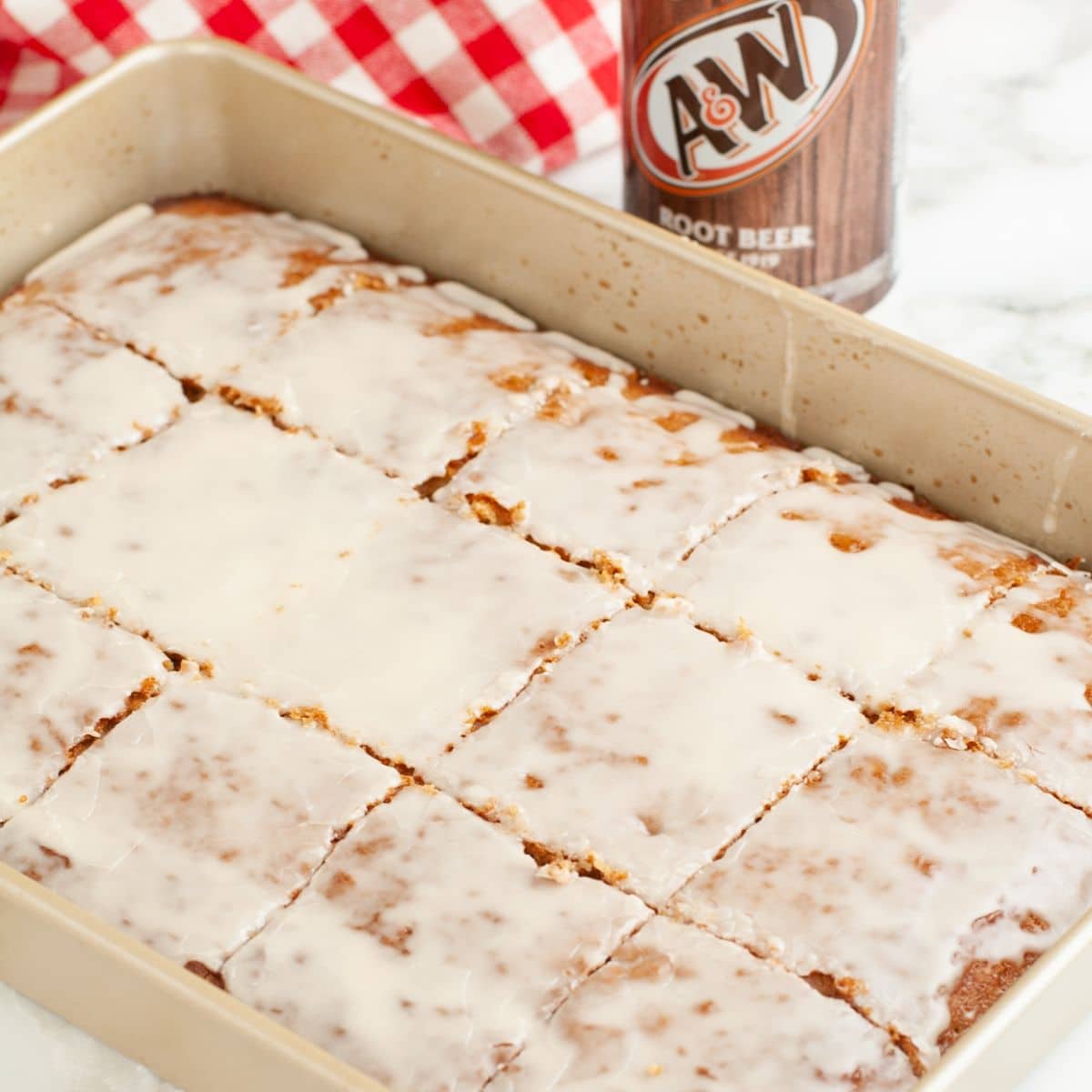 Pan with root beer cake topped with glaze.