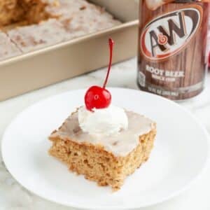 Plate with a piece of root beer float cake and a can of root beer.