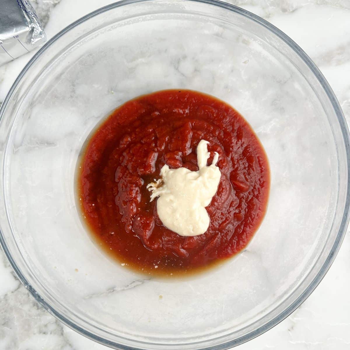 Bowl with chili sauce, horseradish sauce, and Worcestershire sauce. 
