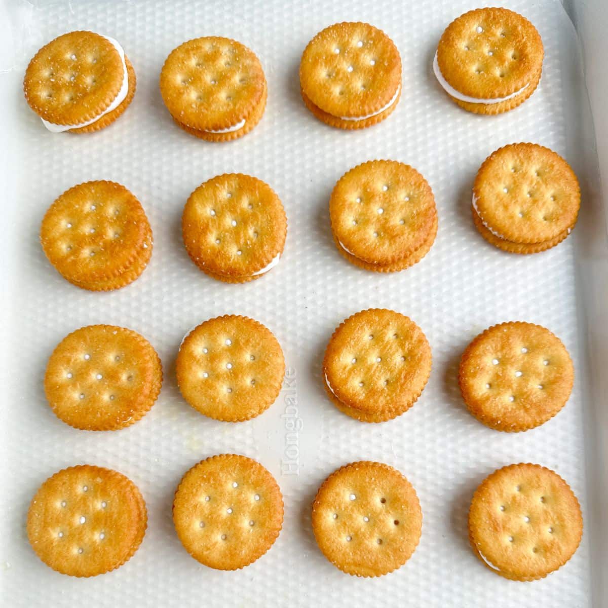 Baking dish with Ritz crackers filled with marshmallow creme.