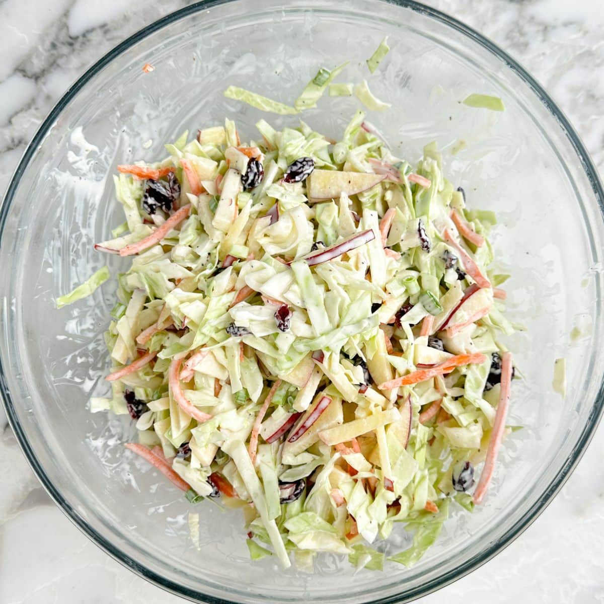 Bowl of coleslaw with apples.