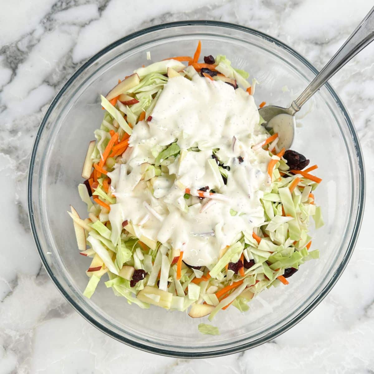 Bowl of slaw with dressing.