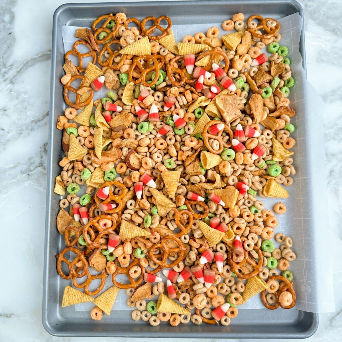 Baking sheet with apple pie snack mix.