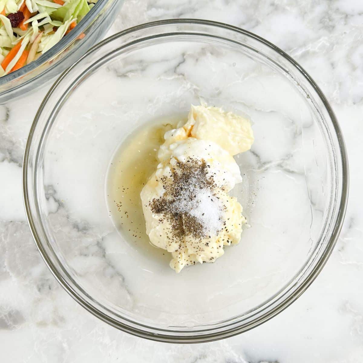 Bowl of mayonnaise, yogurt, honey, and seasonings.