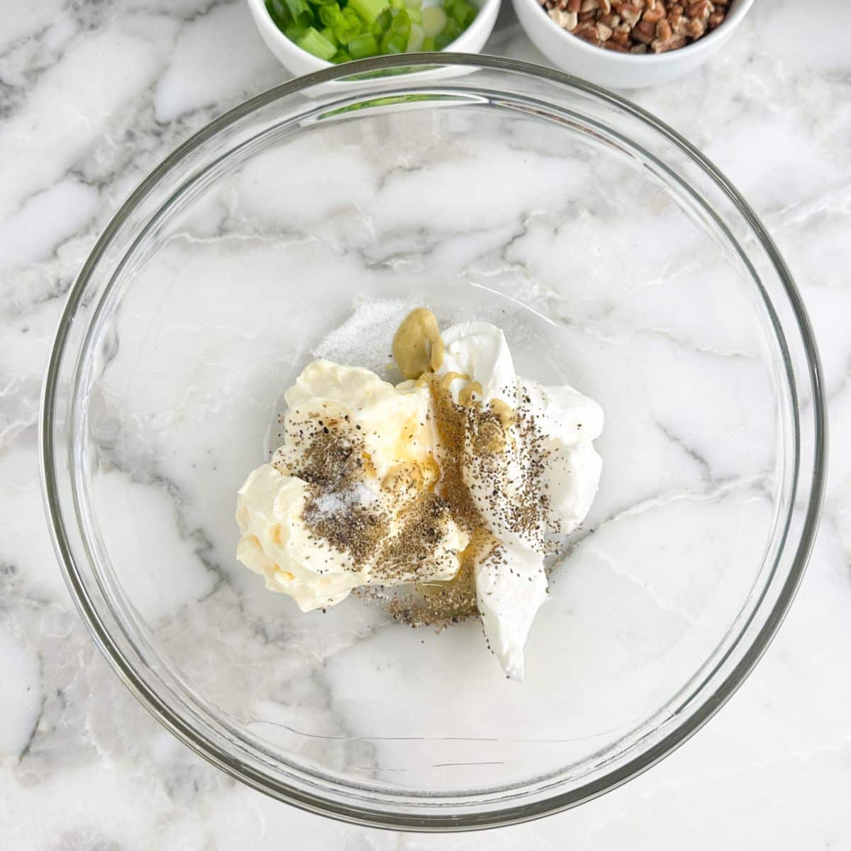 Bowl of mayonnaise, sour cream, honey, and seasonings.