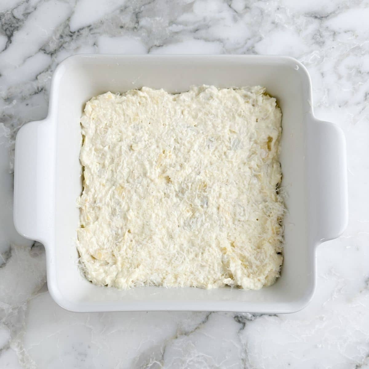Baking dish with artichoke dip.
