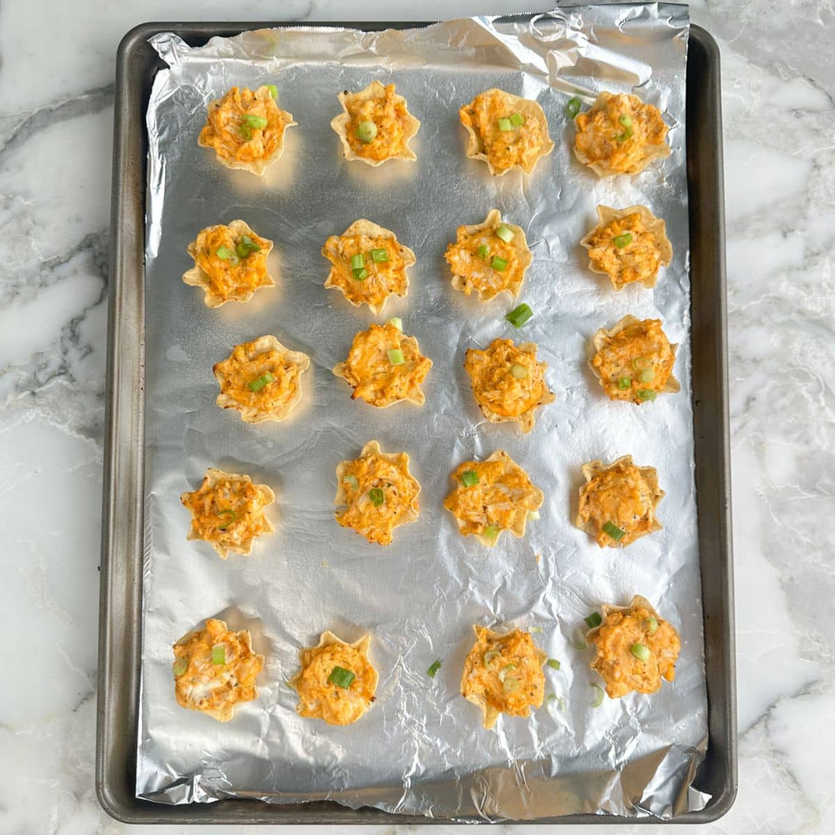 Baking dish with buffalo chicken bites.
