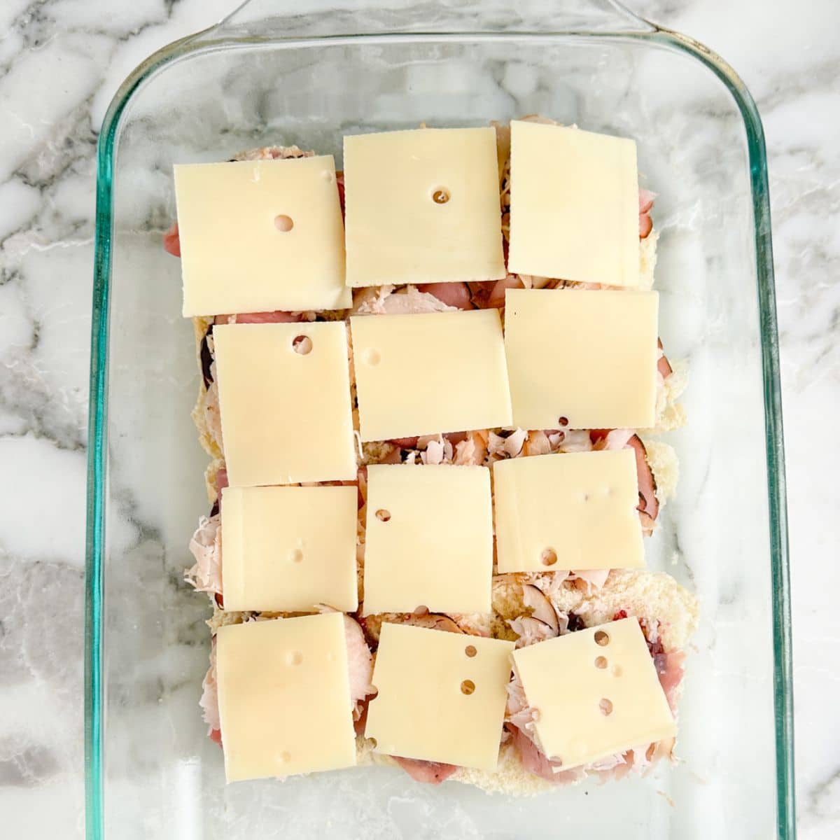 Slider sandwiches with Swiss cheese.