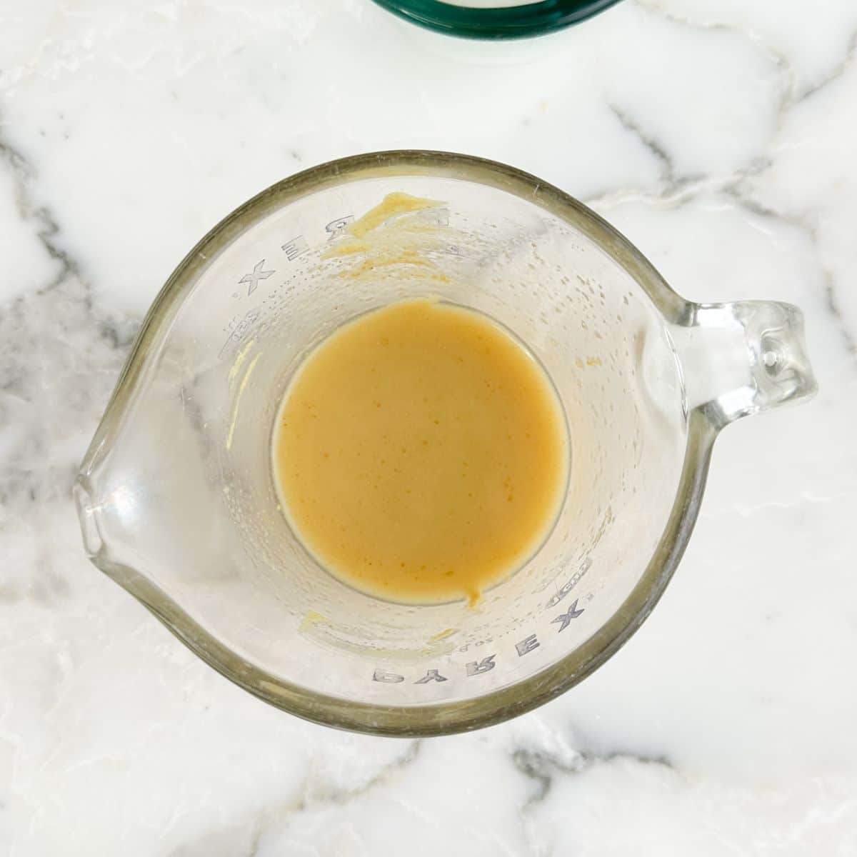 Bowl with melted butter and mustard.