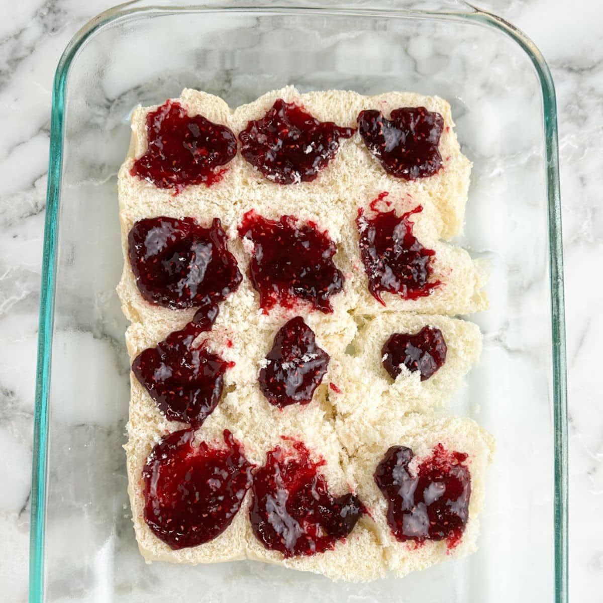 Hawaiian rolls topped with raspberry preserves.