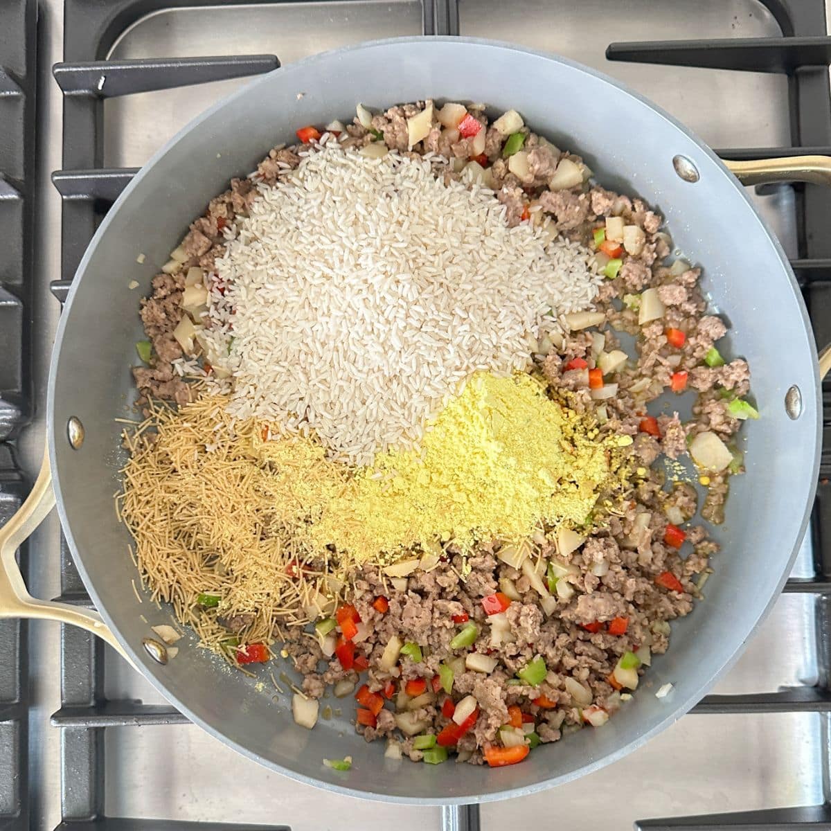 Skillet with ground sausage, rice, and lipton soup.