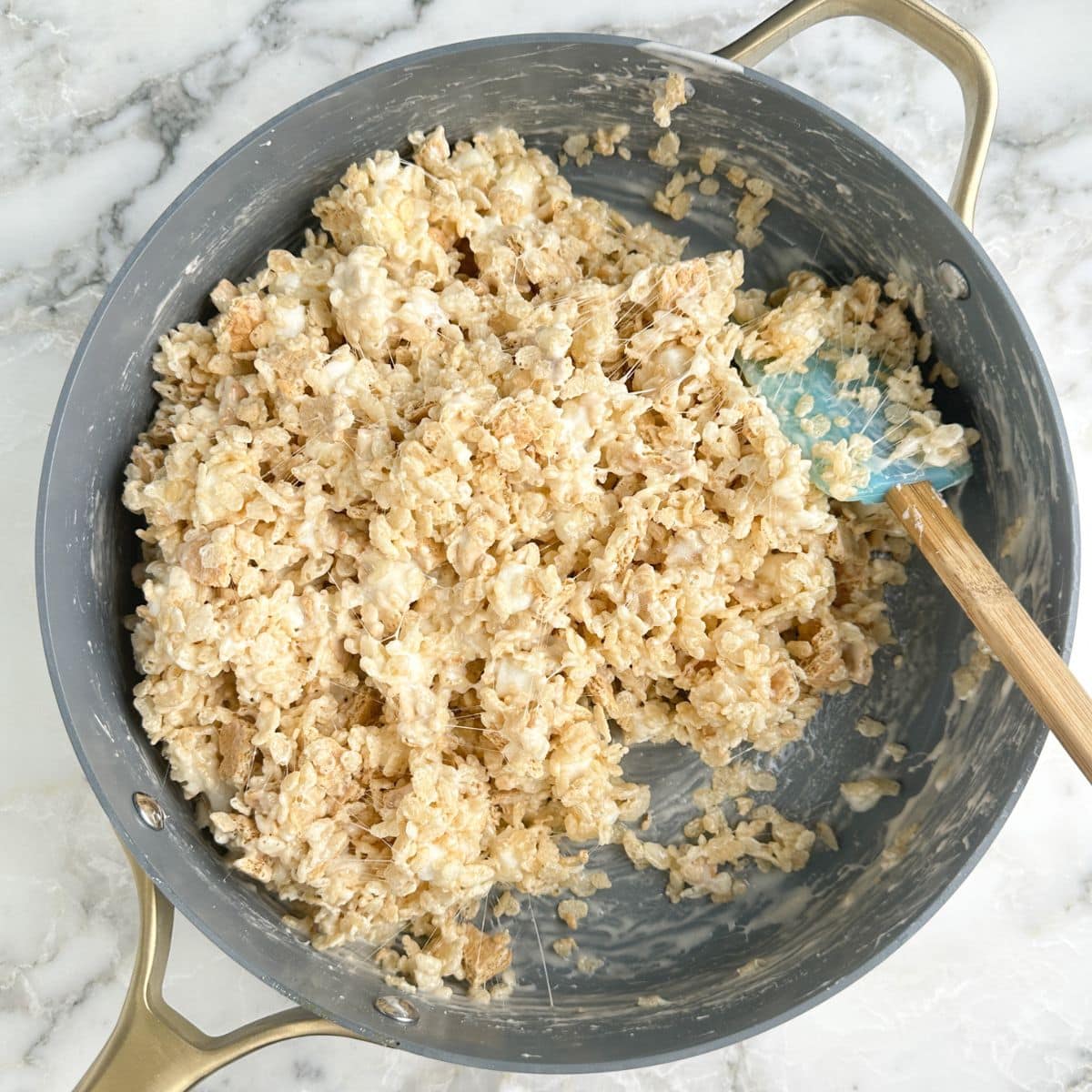 Skillet with rice krispies treat mixture.