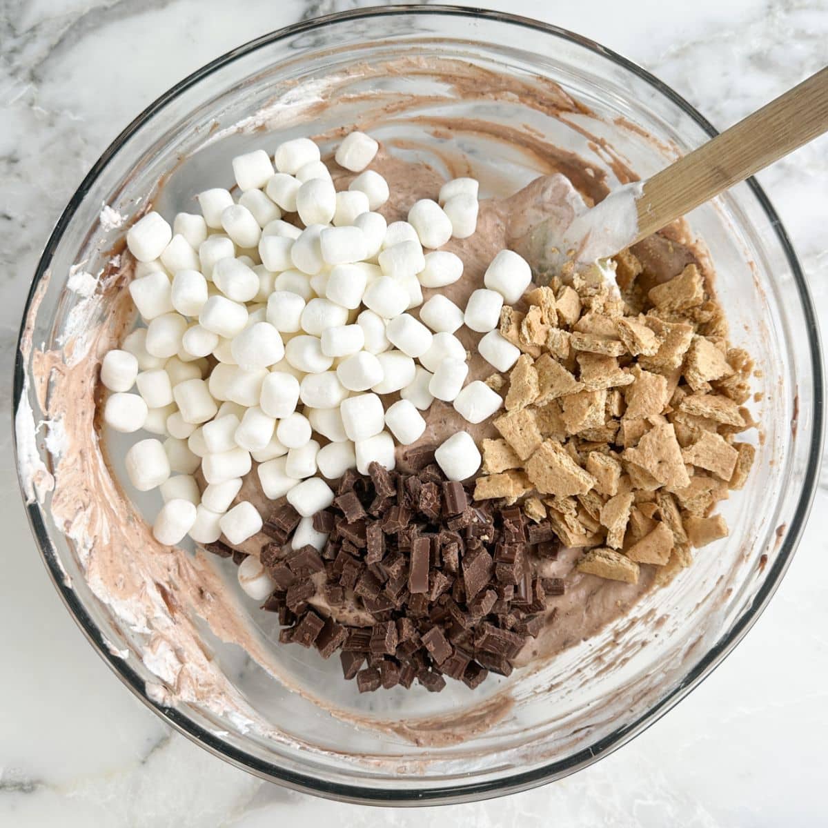 Bowl of chocolate pudding with mini marshmallows, chopped Hershey's bars, and chopped graham crackers.