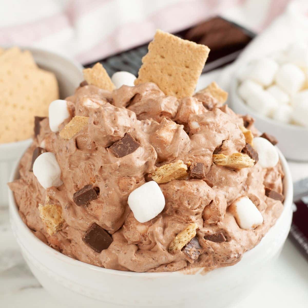 Bowl of s'mores fluff with a graham cracker.